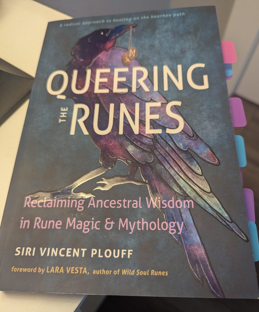 An image of the book Queering the Runes with post-it tabs lined up on it's right edge